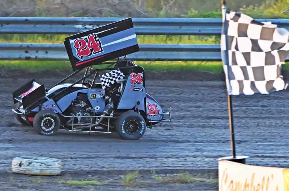 Ryder Wells takes a victory lap after capturing heat win at Gulf Coast Speedway