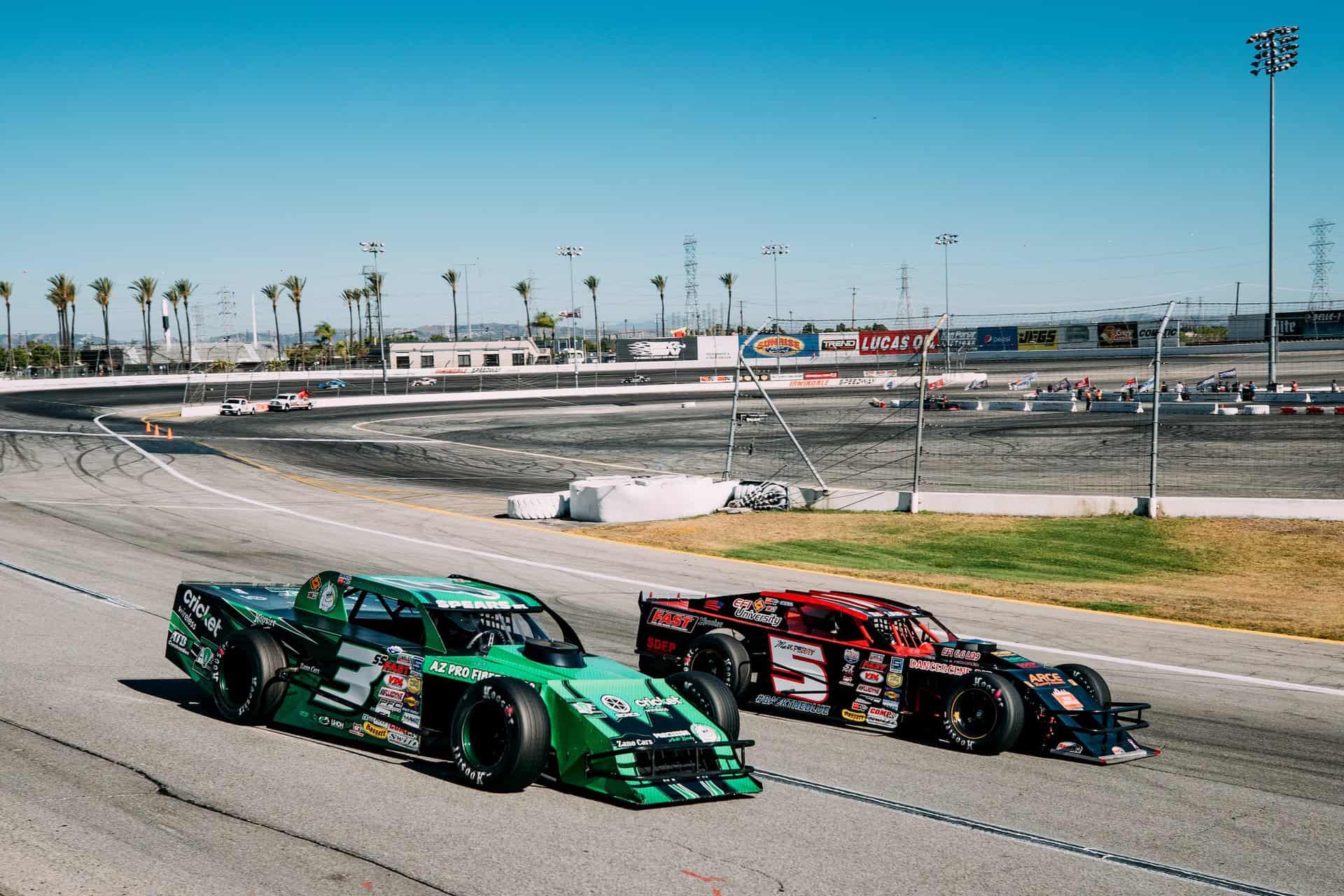 Matt Perry (5) races to the inside of Austin Stewart (3) at Irwindale Speedway in the K&N Filters 60 presented by Traffic Management Inc. on July 18, 2020.