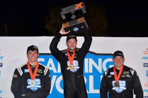 The podium after the srx main event at slinger speedway featured marco andretti splitting luke fenhaus and tony stewart.
