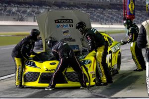 Brandon jones sits on pit road at daytona international speedway. The no. 19 crew works under the hood to address an overheating issue after debris covered the front grill.