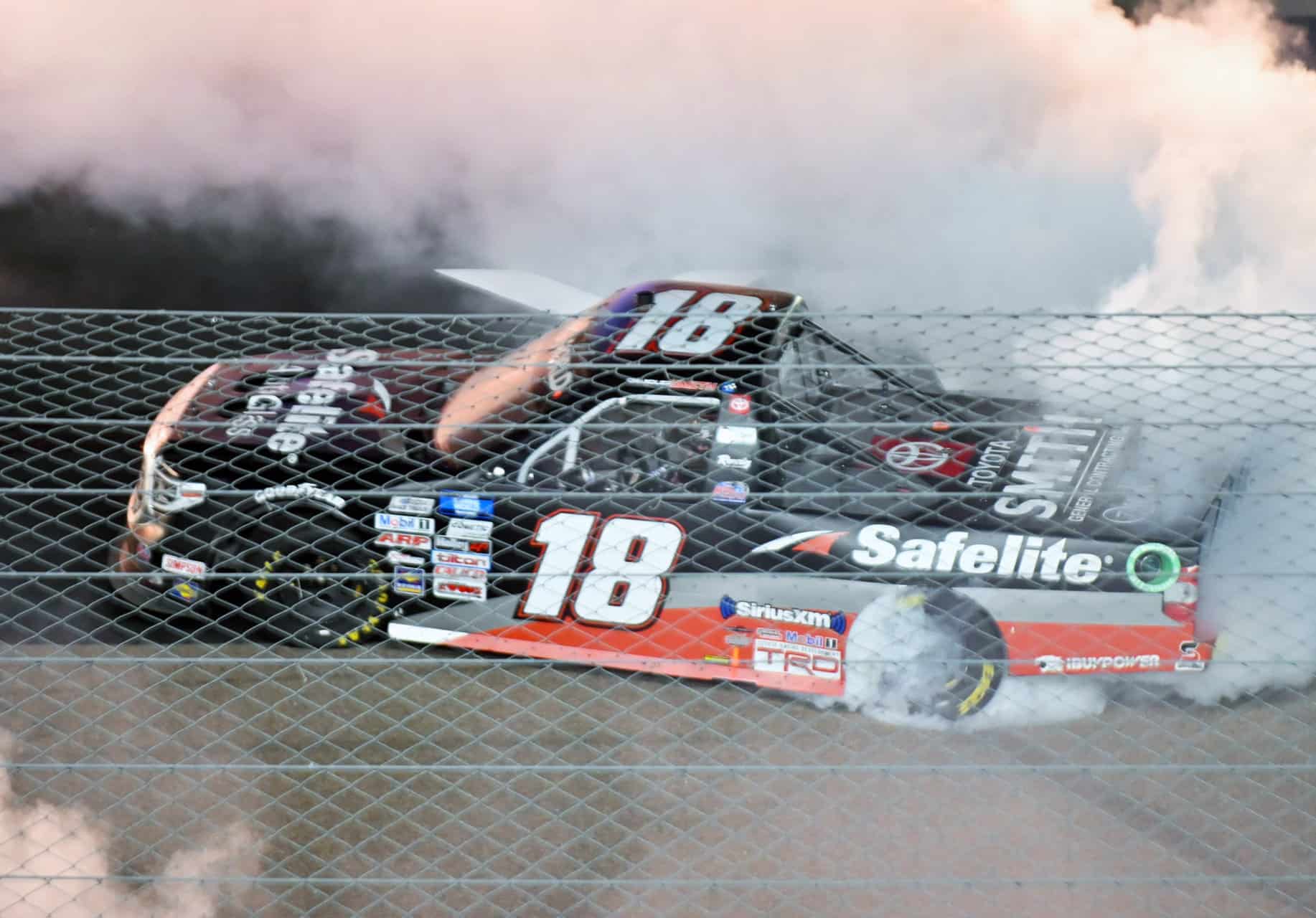 Chandler Smith burns down the tries after winning the truck series race at Phoenix Raceway. Photo by Jerry Jordan/Kickin' the Tires 