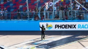 Ty gibbs grabs the checkered flag after winning the 2021 arizona lottery 100 at phoenix raceway in the arca menards series west. Photo by rachel schuoler / kickin' the tires