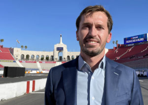 Nascar's senior vice president of strategy and innovation, ben kennedy, stands on the front stretch of the temporary asphalt racetrack built inside the los angeles memorial coliseum. Photo by jerry jordan/kickin' the tires