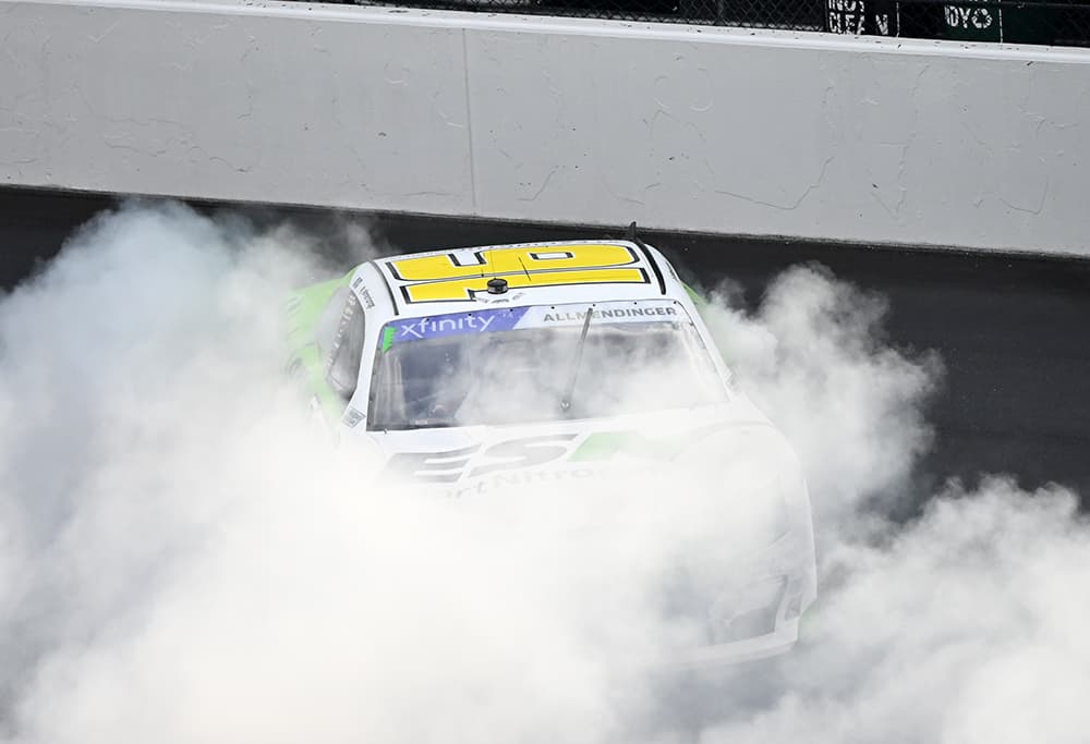 A. J. Allmendinger burns down the tires after taking the checkered flag at the indianapolis motor speedway road course. Photo by jerry jordan/kickin' the tires