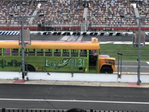 Kaulig racing gives back to short track racing as landon cassill, justin haley, daniel hemric, and chris rice raced school buses in the cook out summer shootout at charlotte motor speedway.