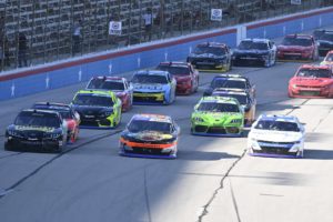 Austin hill makes it three-wide in a late-race restart, avoiding a massive wreck coming out of the turn. Photo by nigel kinrade photography.