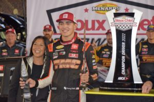 Sammy smith poses with the sioux chief showdown championship trophy in victory lane at bristol motor speedway.