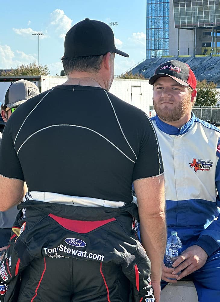 Tony Stewart talks with some of the participants and drivers in the Smoke Show Fantasy Racing Camp during a break at Texas Motor Speedway. Photo by Jerry Jordan/Kickin' the Tires