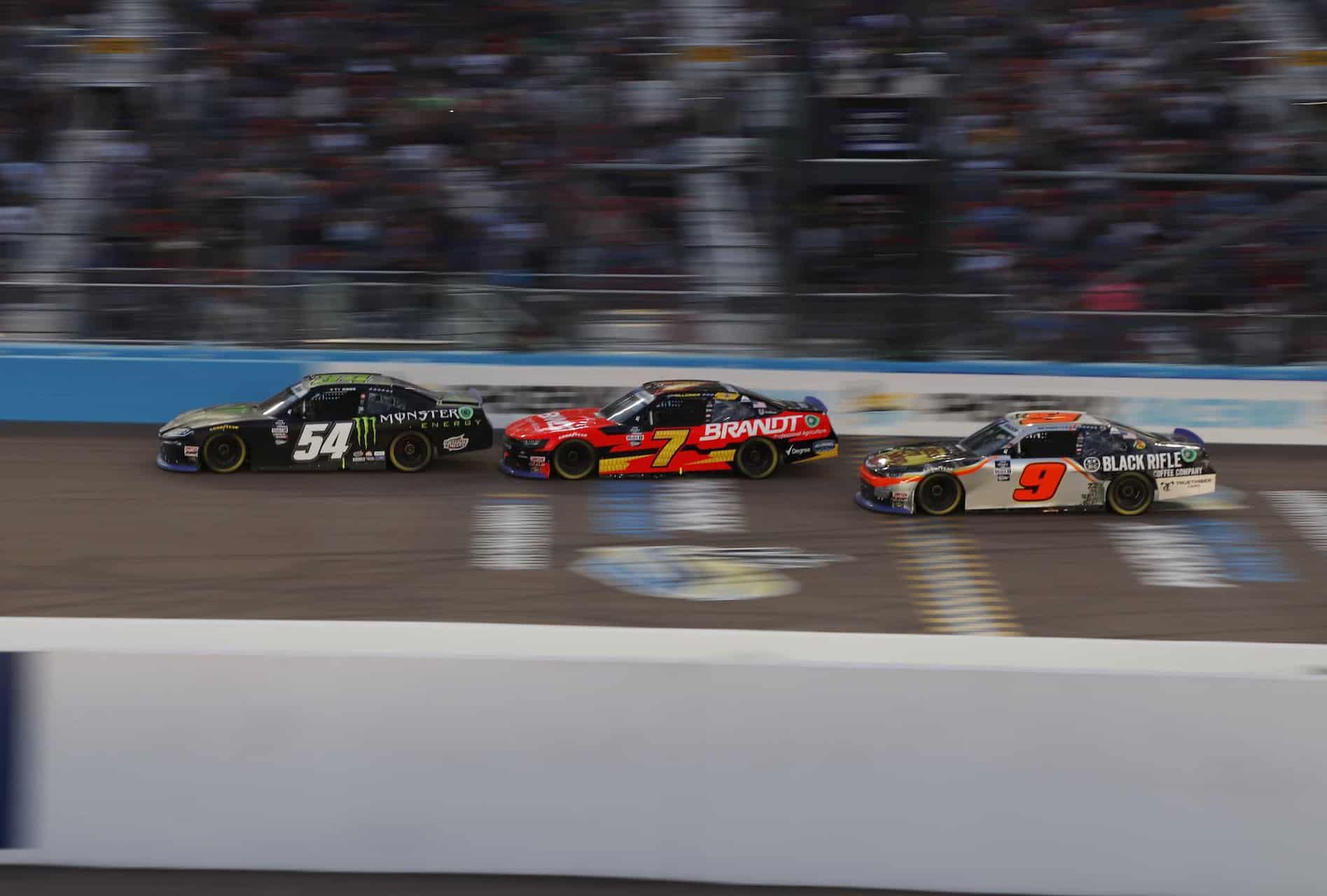Ty gibbs (54) battles with justin allgaier (7) and noah gragson (9) in the closing laps at phoenix raceway. Photo by olivia whissell / kickin' the tires