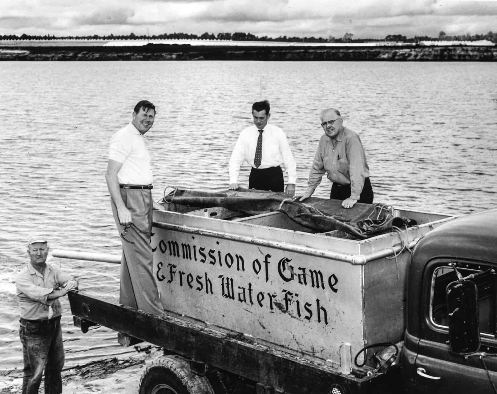 Bill france sr. Works with the commission of game & fresh water fish to fill lake lloyd with bass and catfish. Photo by isc images & archives