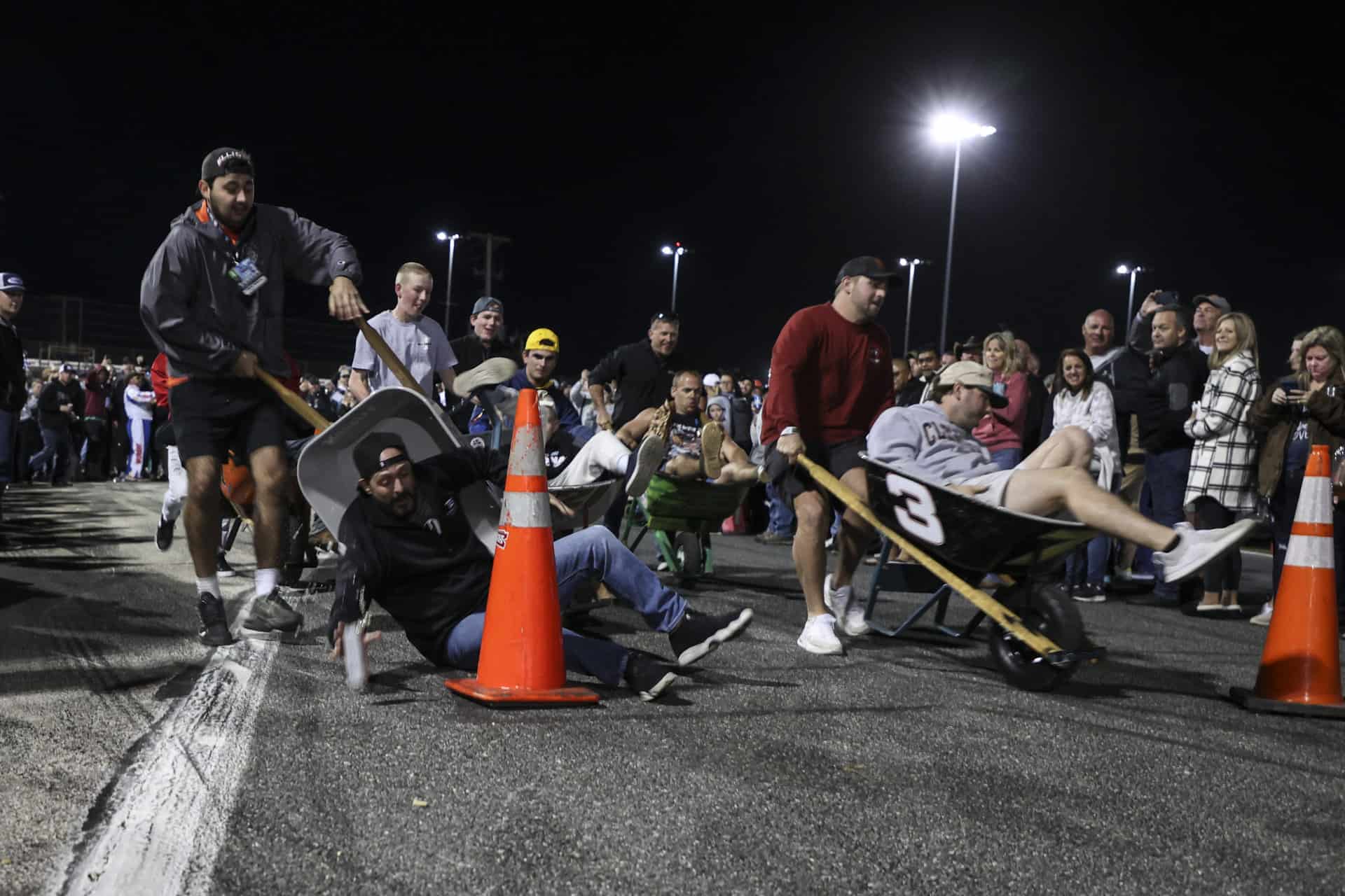 Competitors crash at the loop of the track in the wheelbarrow race of daytona. Photo by rachel schuoler.