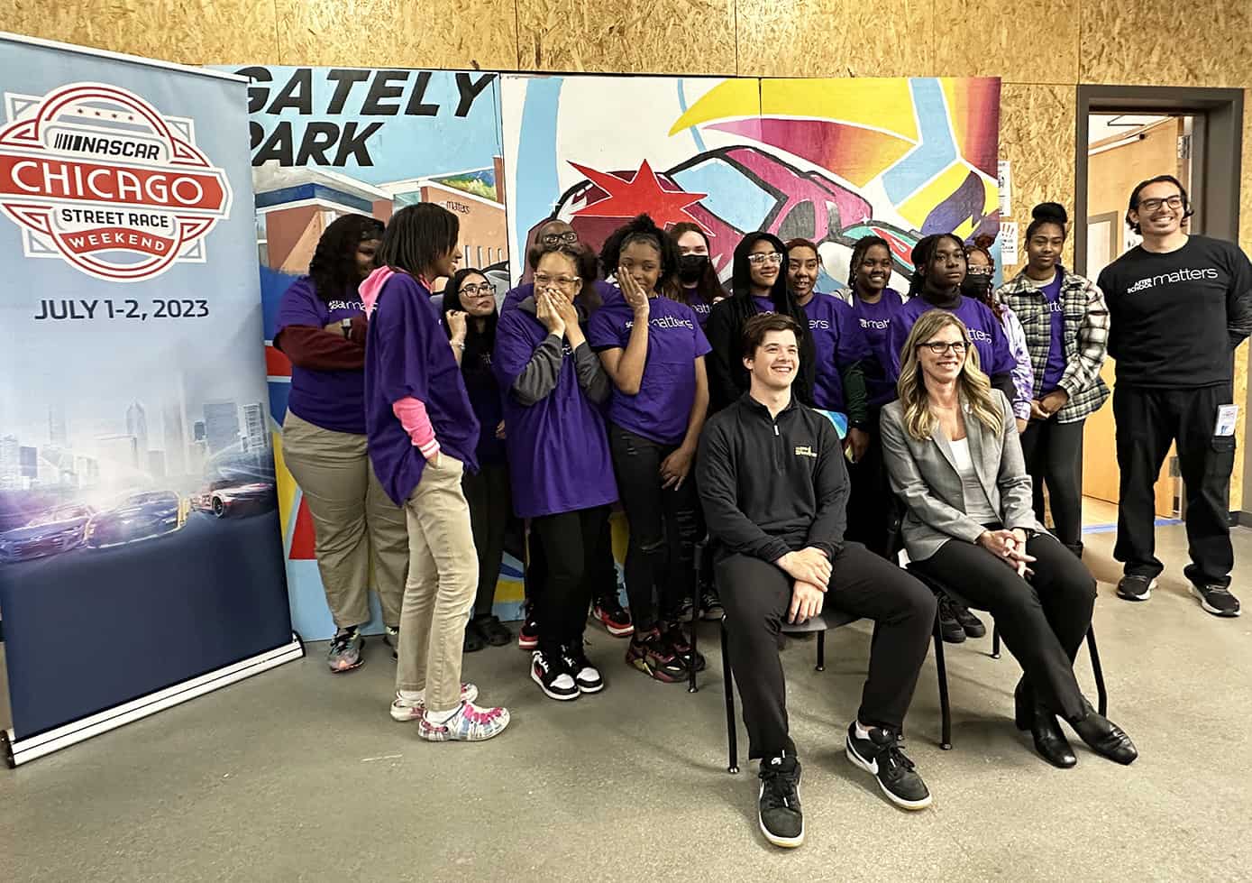 NASCAR driver Harrison Burton and Julie Giese, pose with student who painted several of the panels that will be featured at the upcoming NASCAR Cup Series Chicago Street Race. Photos by Jerry Jordan/Kickin' the Tires