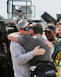 Mallozzi and his father embracing following the nascar truck series race, seven years after his father was diagnosed with cancer and given 6 months to live.