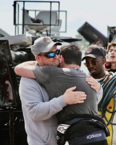 Mallozzi and his father embracing following the NASCAR truck series race, seven years after his father was diagnosed with cancer and given 6 months to live.