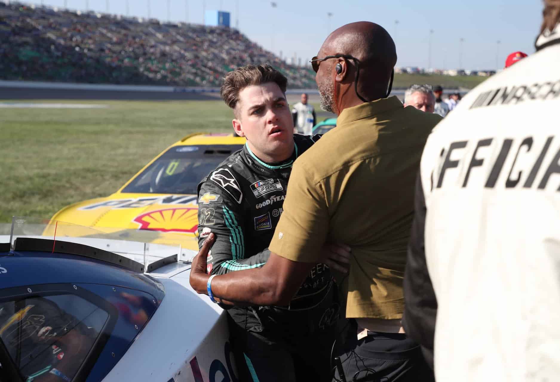 Noah gragson gets pulled away by security guards after confronting ross chastain.