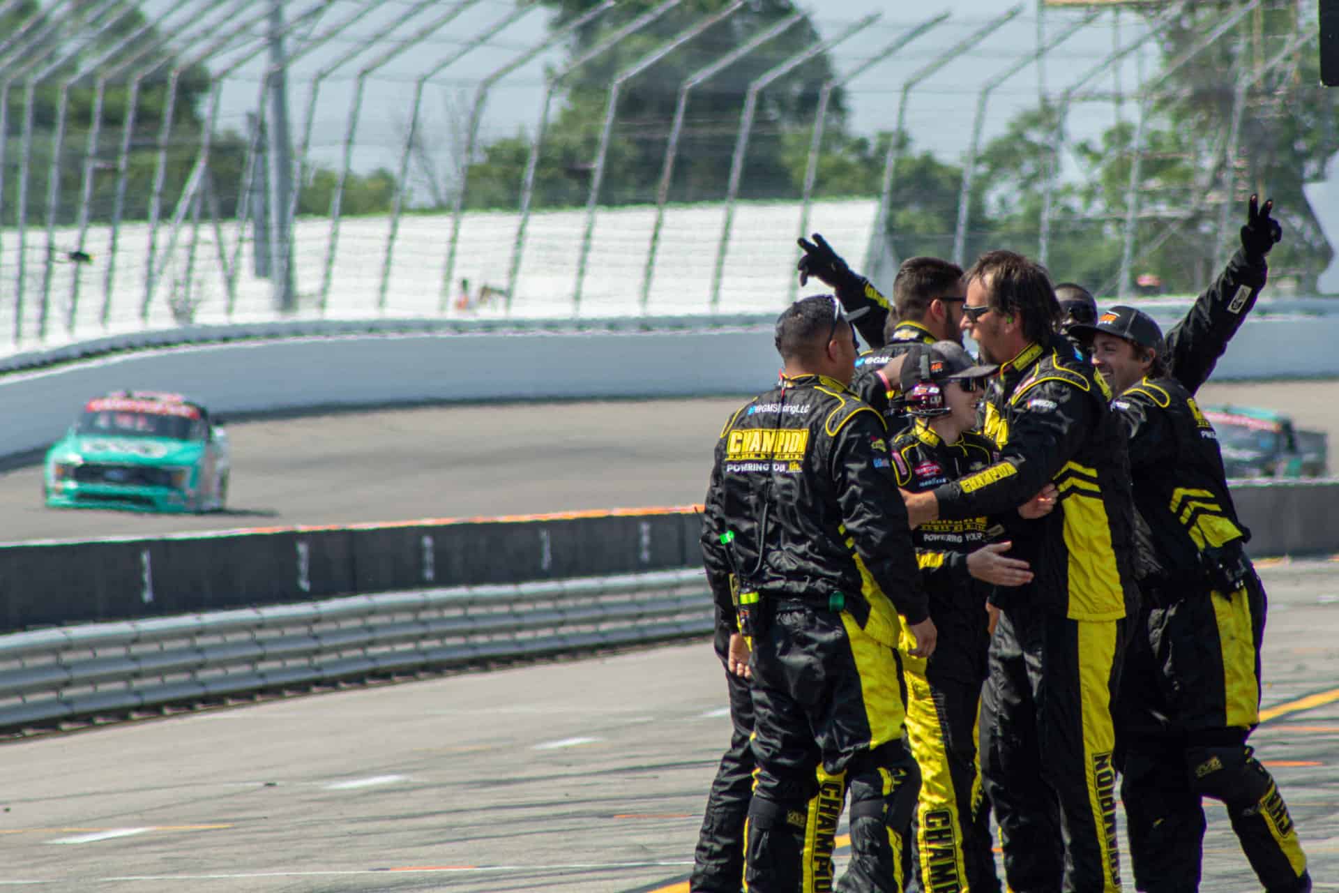 The pit crew for grant enfinger celebrate as they win the 2023 toyota 200 at world wide technology raceway.