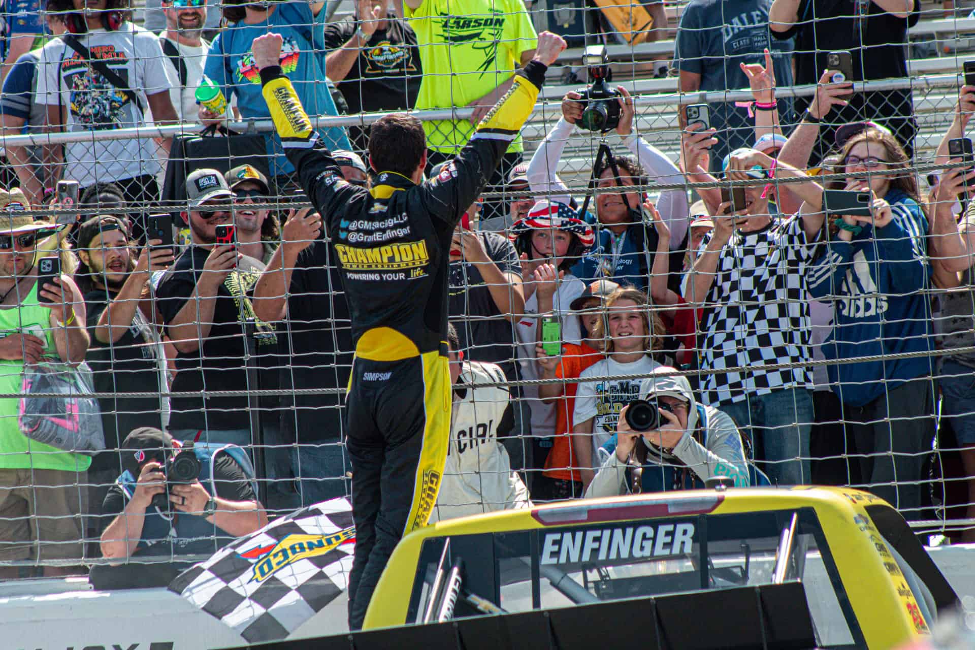 Grant Enfinger climbs out and celebrates with the fans at World Wide Technology Raceway.