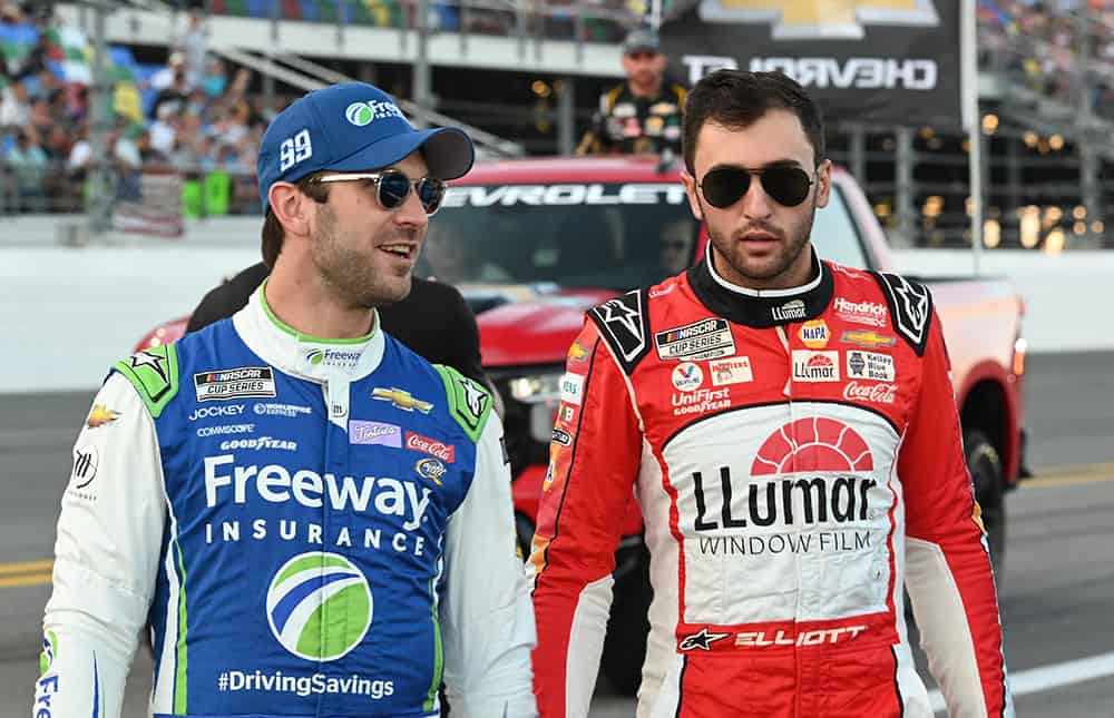 Daniel suarez and chase elliott walk to their cars prior to the 2023 coke zero sugar 400. Photo by jerry jordan/kickin' the tires