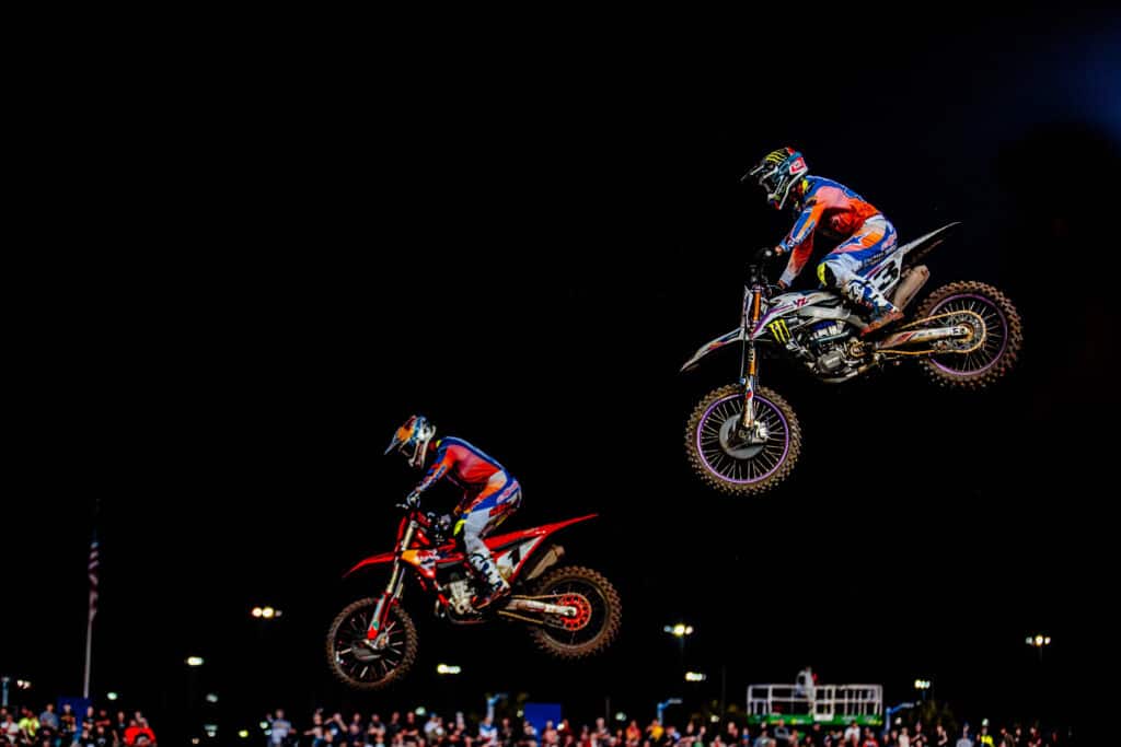Chase Sexton and Eli Tomac battle for position during the 2024 450SX Daytona Supercross race.