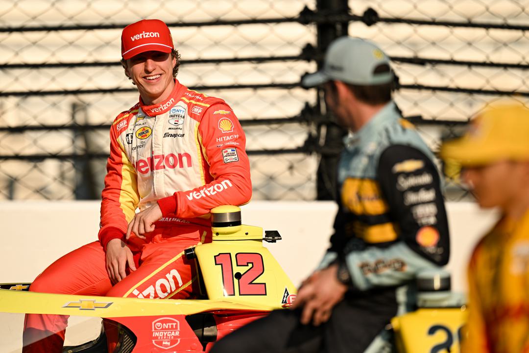 David Malukas and Alexander Rossi sit atop their cars for the 2026 Indy 500 Front Row photoshoot.