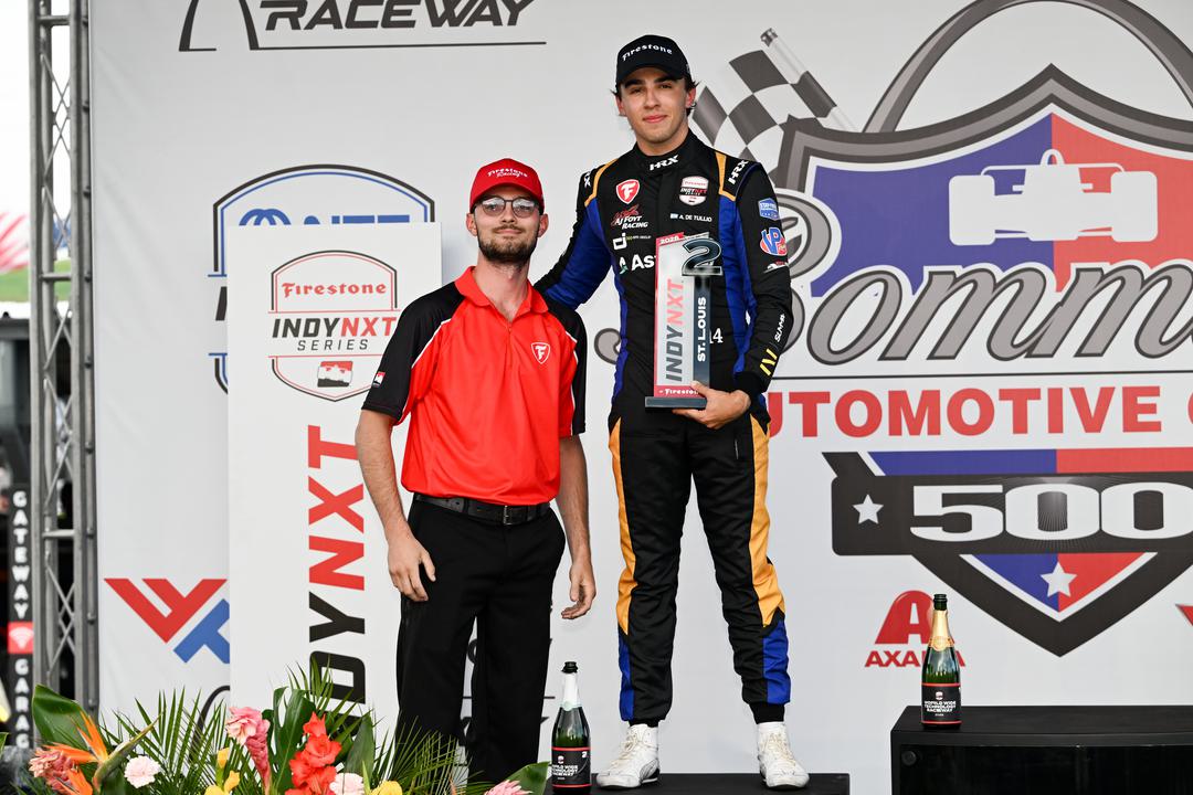Alessandro de Tullio stands on the podium holding his second-place trophy after a runner-up finish at Gateway in his oval debut.